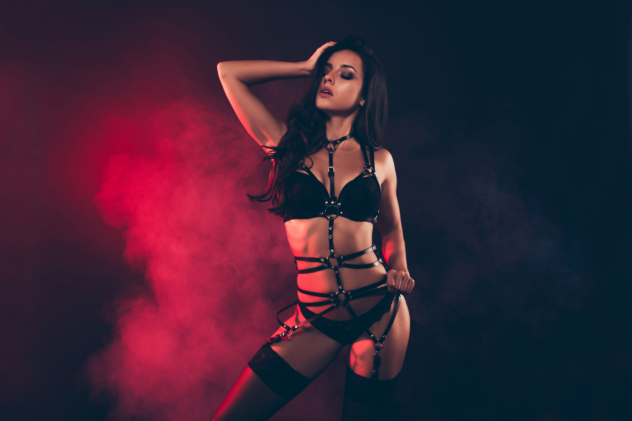 Auckland Escorts Woman in black strappy lingerie.